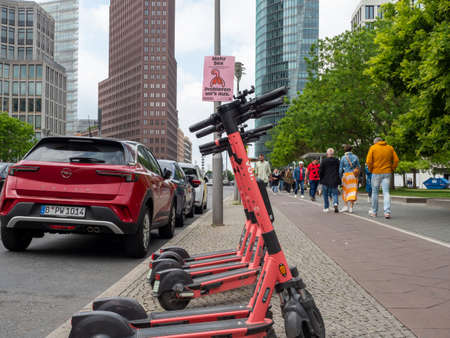 BERLIN, GERMANY - May 21, 2022; Electric scooters on the background of skyscrapers. Potsdamer Platz. May 21, 2022 Berlin Germanyのeditorial素材