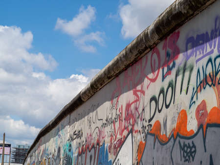 BERLIN, GERMANY - June 02, 2022. It is part of the original Berlin Wall and is a famous memorial with a lot of graffiti. BERLIN, GERMANY - June 02, 2022.のeditorial素材