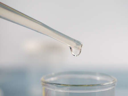 Analytical chemistry - sample being pipetted into test tube for analysis in laboratory.の写真素材