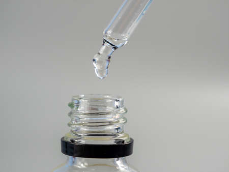 Oil for skin care is dripping with a pipette. Close up.の写真素材