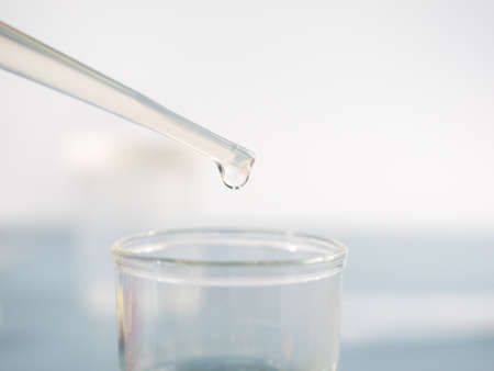 Analytical chemistry - sample being pipetted into test tube for analysis in laboratory.の写真素材