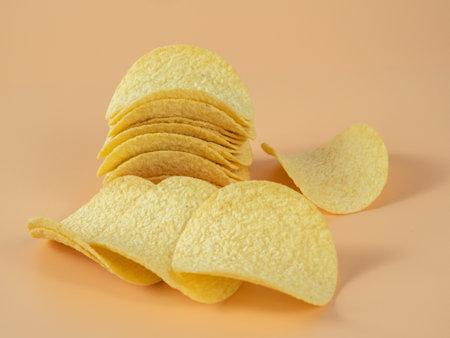 crisps Crispy potatoes. Potato chips on an orange background. Close up.の写真素材