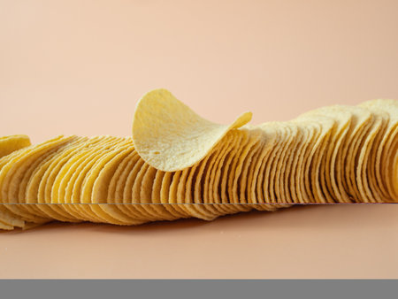 crisps Crispy potatoes. Potato chips on an orange background. Close up.の写真素材