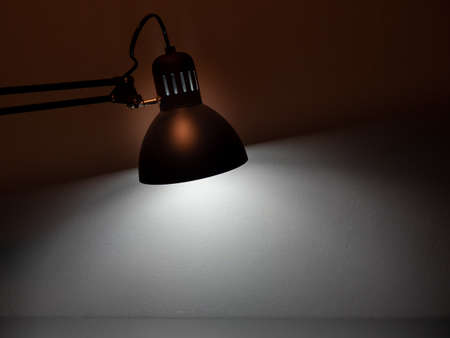 Table gray lamp on a gray background. The lamp shines on a gray background.の写真素材