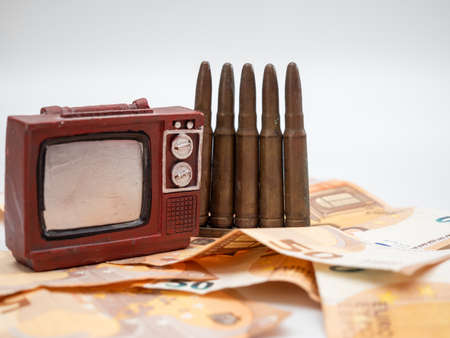 Cartridges for weapons and TV are on the money. Ammo and euros. The concept of information warfare.の写真素材