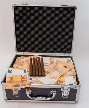 Bullet and euro money lie in a suitcase, armament money concept.の写真素材