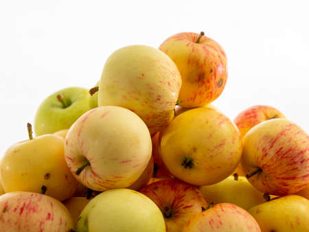 Fresh red apples on a wooden table with a white background. Apples from the garden.の写真素材