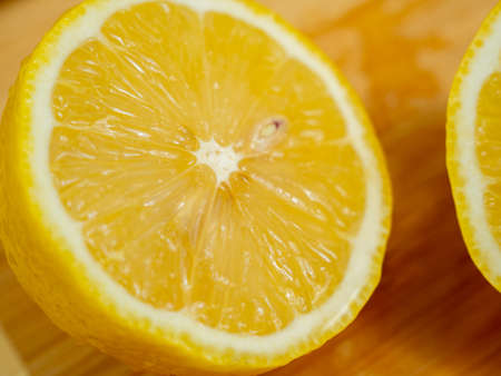 Sliced fruits. Ripe lemon on a wooden board. Fresh lemons on a wooden background.の写真素材