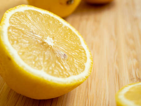 Sliced fruits. Ripe lemon on a wooden board. Fresh lemons on a wooden background.の写真素材