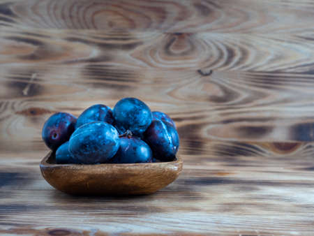 Fresh juicy plums. Plums on a wooden background. close upの写真素材