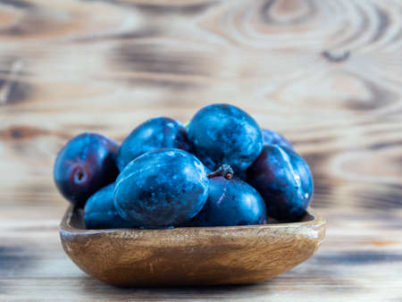 Fresh juicy plums. Plums on a wooden background. close upの写真素材