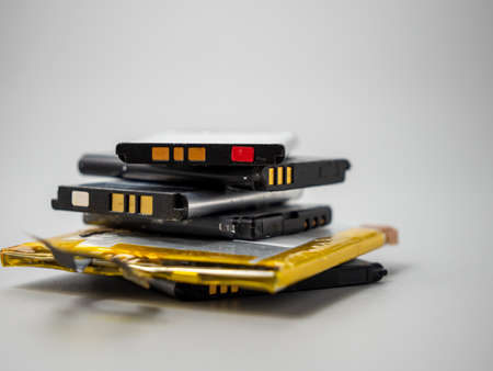 Old phone batteries. Replaceable batteries. Phone batteries. Batteries on a gray background. .の写真素材