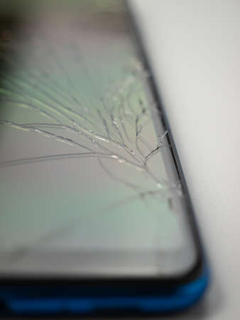 Old smart phone. Broken phone. Phone on a gray background. Broken smartphone.の写真素材