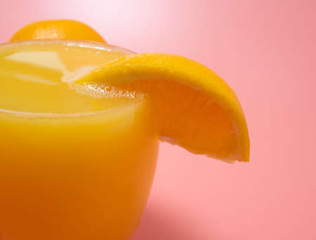 Orange and orange slices. Orange Juice Splashing. Orange on a pink background. Orange close up.の写真素材