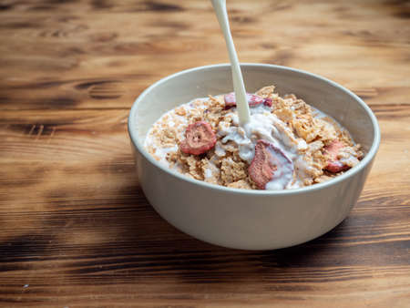 A cup with muesli and fresh berries on a wooden table. Healthy food, snack or breakfast. Healthy food.の写真素材