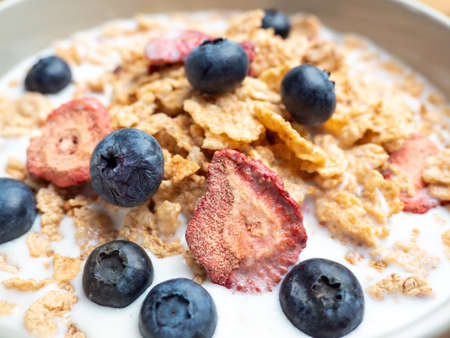 A cup with muesli and fresh berries on a wooden table. Healthy food, snack or breakfast. Healthy food.の写真素材