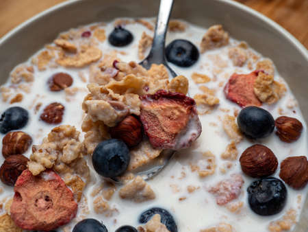 A cup with muesli and fresh berries on a wooden table. Healthy food, snack or breakfast. Healthy food.の写真素材