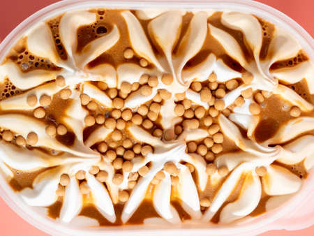 Caramel ice cream on a pink background. Ice cream close-up.の写真素材
