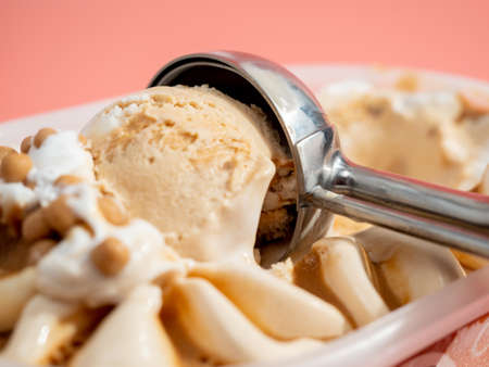 Caramel ice cream on a pink background. Ice cream close-up.
