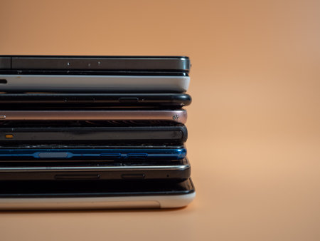 Old broken smartphone. Smartphone on an orange background. Close up.の写真素材