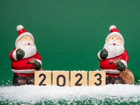 The inscription in wooden letters 2023 on a green background. Close up.の写真素材