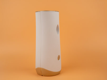 Air freshener on an orange background. Automatic air freshener. Close up.の写真素材