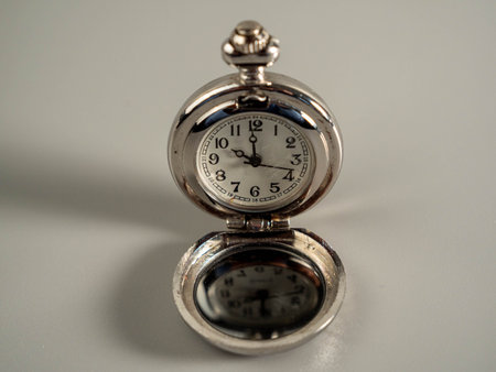 Old pocket watch on a gray background. Time concept.