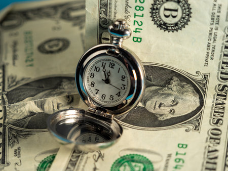 Old pocket watches lie on dollar bills. Close up.の写真素材