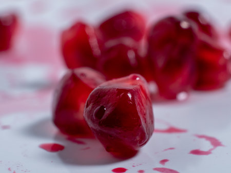 Ripe pomegranate. Fresh juicy pomegranate seeds on a light background. Close up.の写真素材