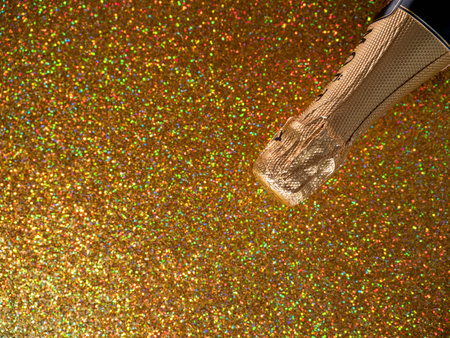 Bottle of champagne with gold glitter on a shiny background. fun partyの写真素材