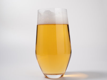 Glass of beer on a white background. A glass of light beer with foam. close up.の写真素材