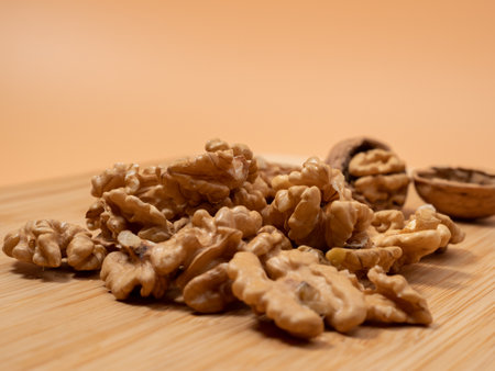Walnut on an orange background. Raw walnuts. Close up.
