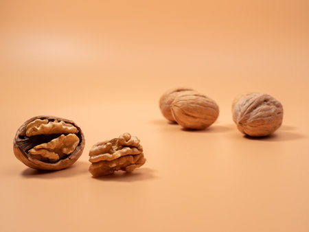 Walnut on an orange background. Raw walnuts. Close up.の写真素材