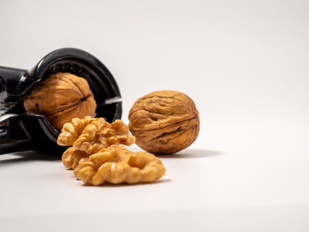 Walnut and nutcracker on a white background. Raw walnuts. Close up.の写真素材