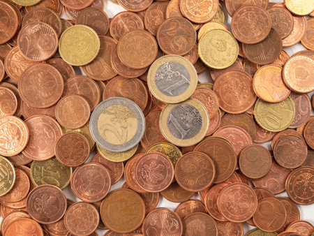 Lots of metal coins. A bunch of euro cents. Close up.
