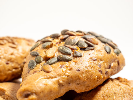 Dark buns on a white background. Bakery products with grains. Close up.