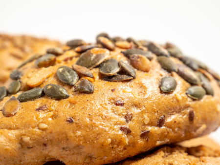 Dark buns on a white background. Bakery products with grains. Close up.