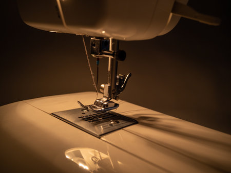 Electric sewing machine on a dark background. Close up.