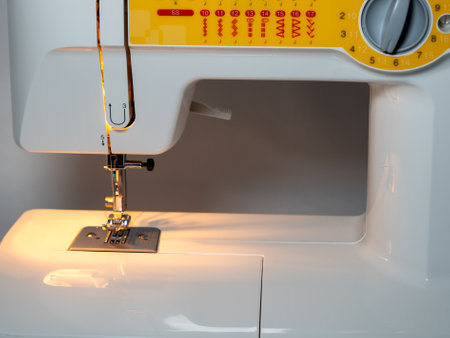Electric sewing machine on a white background. Close up.