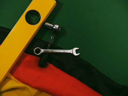 German flag and work tool on green. ConceptMade in Germany. German quality.
