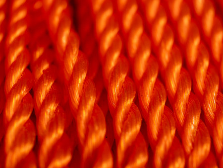 Orange rope close up. Texture of braided rope. Orange background.の写真素材