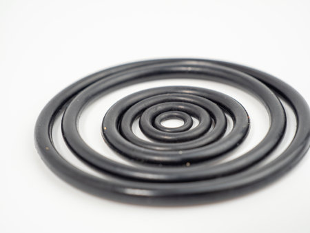 Hydraulic and pneumatic o-rings in black in different sizes on a white background. Rubber gaskets...