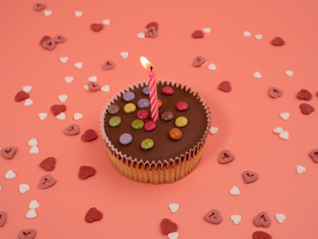 Muffin with a candle on a pink background. Holiday muffins. Close up.の写真素材
