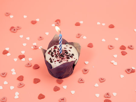 Muffin with a candle on a pink background. Holiday muffins. Close up.の写真素材