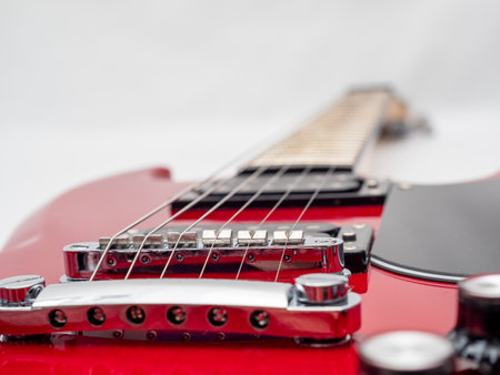 Red electric guitar isolated on white background. Musical instrument guitar. Close up.