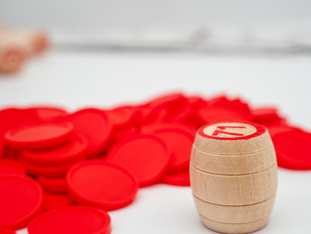 Board game bingo. Wooden barrels with lotto numbers, playing cards for the game. Close up.の写真素材