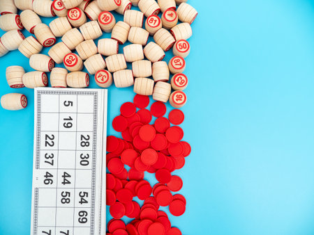 Board game bingo. Wooden barrels with lotto numbers, playing cards for the game. Close up.の写真素材