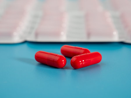 Red medical capsules. Capsules in a blister pack. Close up.
