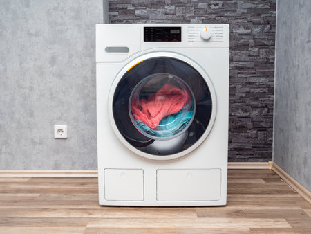 Laundry room interior with washing machine against the wall. Modern washing machine.の写真素材