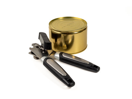Can opener with tin can isolated on white background. Metal can opener. Close up.の写真素材